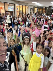 Kids dancing to music at a halloween concert